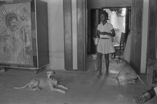 Girl and dogs inside building, San Basilio de Palenque, ca. 1978