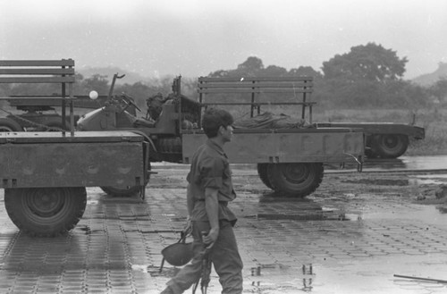 Soldier walks near a covered corpse, Nicaragua, 1979