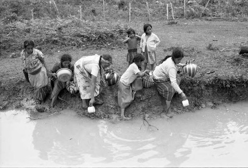 Group of women and children refugees collect water, Chiapas, 1983