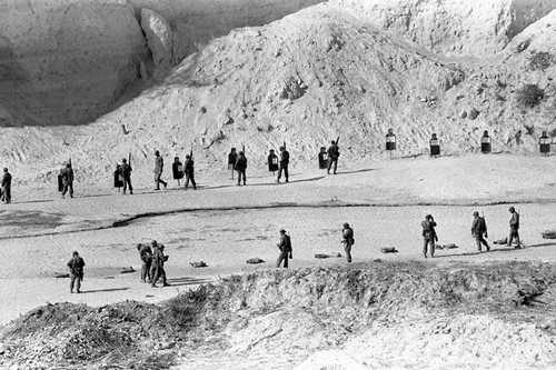 U.S. advisor training Salvadoran soldiers at a shooting range, Ilopango, 1983