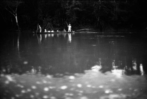 Two refugee men steer a canoe through a river, Chiapas, 1983