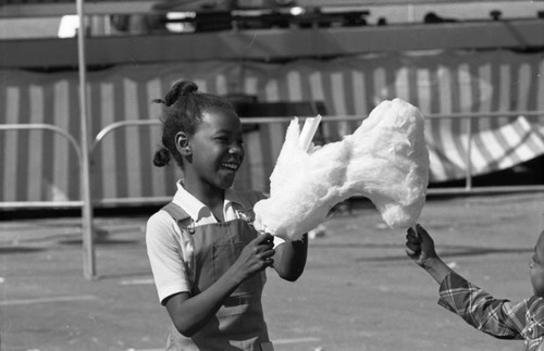 Children holding cotton candy