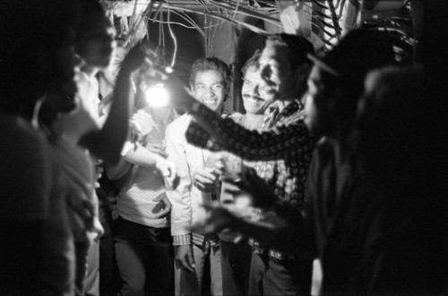 Men celebrating in the evening, Barranquilla, Colombia, 1977