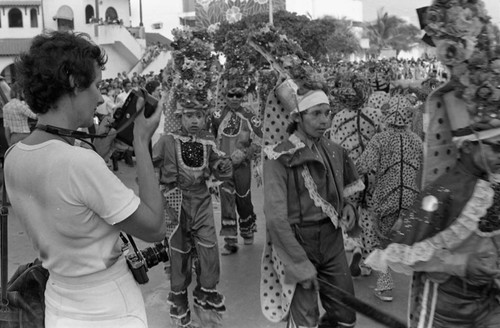 Woman photographing dancers, Barranquilla, Colombia, 1977