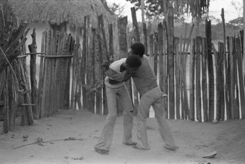 Boys boxing in front of a fence, San Basilio del Palenque, ca. 1978