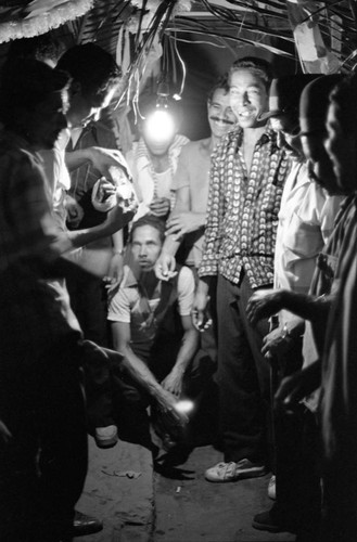 Men celebrating in the evening, Barranquilla, Colombia, 1977