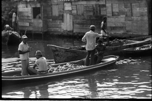 Men on boats loaded with bananas, Cartagena Province, 1975