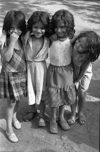 Young girls laughing and embracing, Santa Tecla, La Libertad, 1982