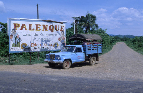 Truck and billboard welcoming people to Palenque, San Basilio de Palenque, 1976