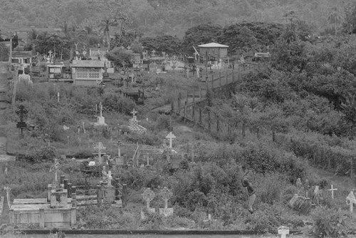 Distant view of a man landscaping a cemetery, Barbacoas, Colombia, 1979