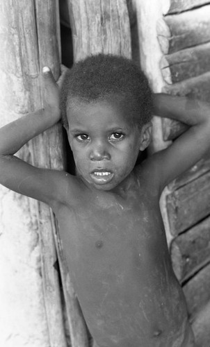 Boy leaning on door, San Basilio de Palenque, 1976