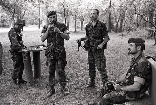 Survival school students stand near Harry Claflin and an assistant, Liberal, 1983