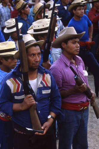 Mayan men holding shotguns during an army training on civil defense, Chajul, 1982