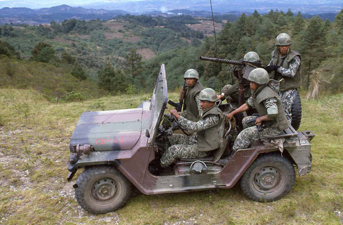 Soldiers in a jeep on patrol, Guatemala, 1982