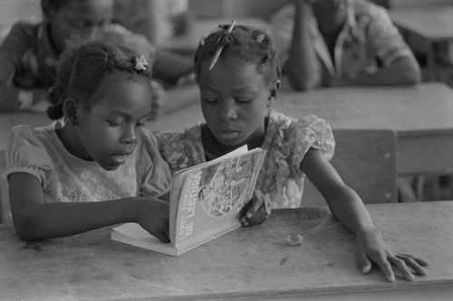 Students in a classroom reading a book, San Basilio de Palenque, ca. 1978