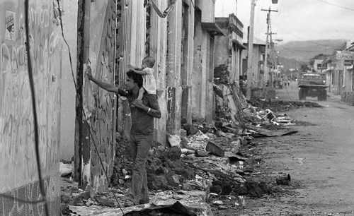 Man carries baby, Estelí, 1980