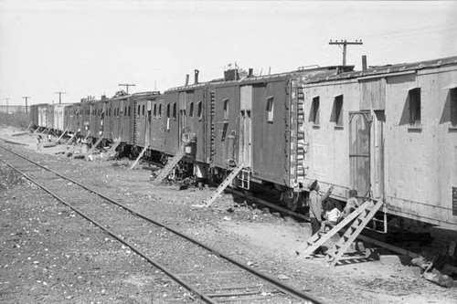 Line of 12 train cars converted into homes, Pacheco, 1983