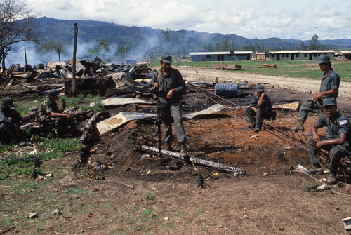 Five Contra soldiers rest among debris, Nicaragua, 1983