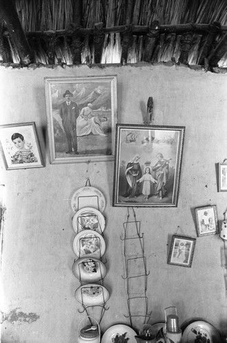 Paintings and dishes hanging from the wall, San Basilio de Palenque, 1976