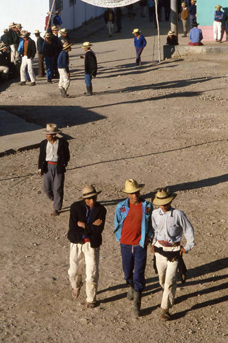 Mayan men walk down a street in Chajul, Chajul, 1983