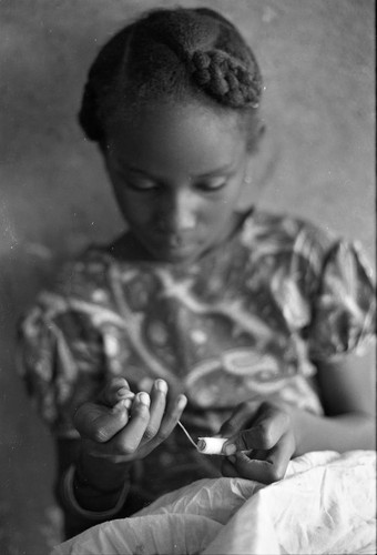 Girl sewing a garment, San Basilio de Palenque, 1977