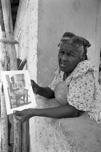 Woman holds a portrait, San Basilio de Palenque, 1977