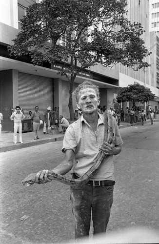 Man holding a snake, Barranquilla, Colombia, 1977