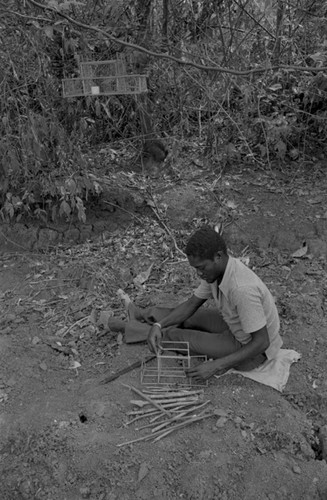 Young man building an animal trap, San Basilio de Palenque, 1977