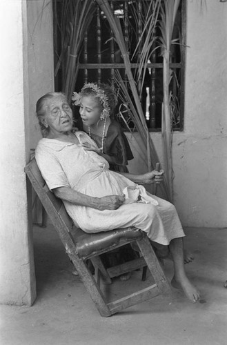 Girl talking with an elderly woman on a veranda, Barranquilla, Colombia, 1977