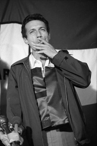 Roberto D'Aubuisson smokes during a press conference, San Salvador, 1982