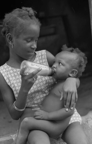 Girl feeding a baby, San Basilio de Palenque, 1976