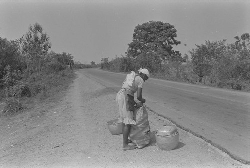 Woman setting up a selling stand by the road, Cartagena Province, ca. 1978