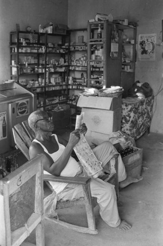 Fermín Herrera reads the newspaper, San Basilio de Palenque, Colombia, 1977