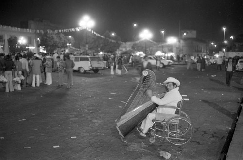 Man using wheelchair plays the harp, Mexico City, 1982