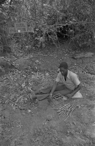 Young man building an animal trap, San Basilio de Palenque, 1977