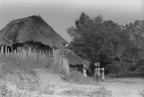 Girls walking with buckets on their head, San Basilio de Palenque, 1976