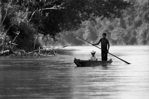 Two refugee men in a canoe, Chiapas, 1983