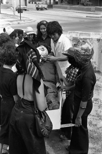 Men and women holding a mannequin in a coffin, Barranquilla, Colombia, 1977