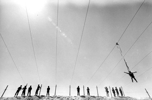 Salvadoran soldiers practice parachuting at military air base, Ilopango, 1983