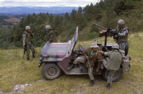 Armed soldiers in a jeep patrol a mountainous area, Guatemala, 1982