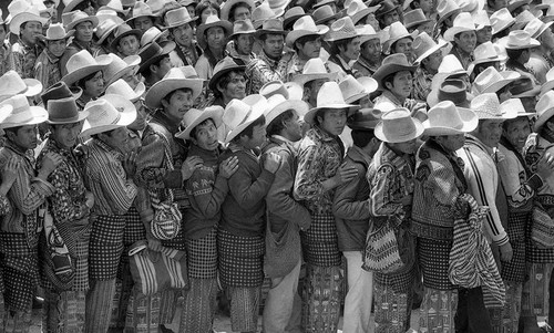 Mayan men wait in a long line to vote, Guatemala, 1982