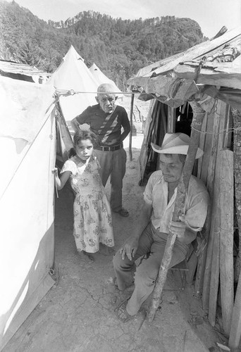 Refugees between shelters in refugee camp, Department of Morazán, 1983