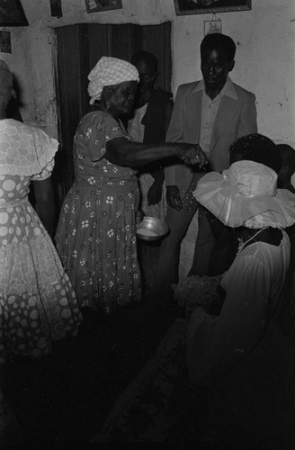 Woman throwing rice at wedding couple, San Basilio del Palenque, ca. 1978