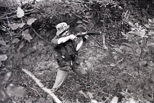 Survival school student holds a rifle, Liberal, 1982