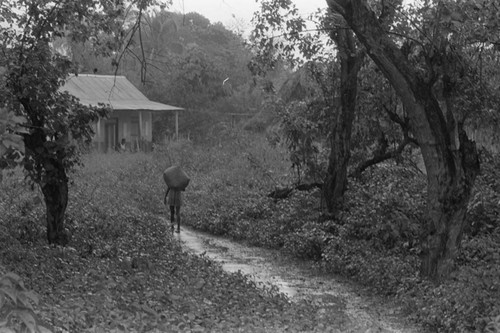 Girl walking on a trail, San Basilio de Palenque, 1976