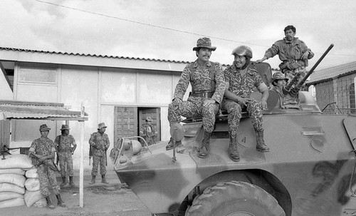 Soldiers on an armored car at a military post, Guatemala, 1982