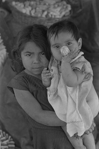 Little girl with hungry baby, Perquín, Morazán, 1983