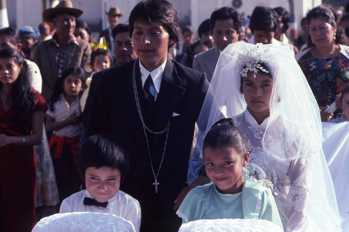 Young bride and groom with wedding attendees, Chiquimula, 1982