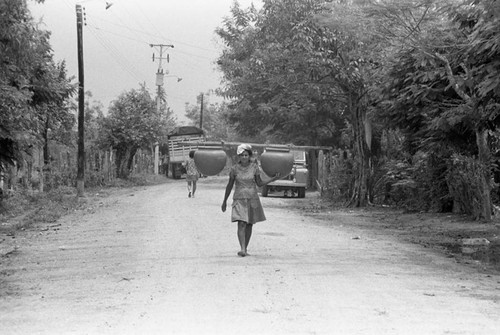 Transporting clay goods, La Chamba, Colombia, 1975