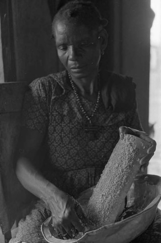 Woman grating coconut, San Basilio de Palenque, 1975